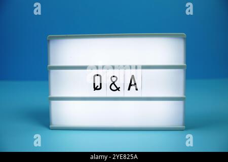 Q & A (Question and Answer) letterboard text on LED Lightbox on blue background Stock Photo