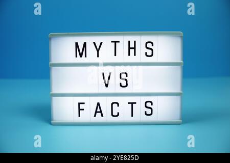 Myths vs Facts letterboard text on LED Lightbox on blue background Stock Photo