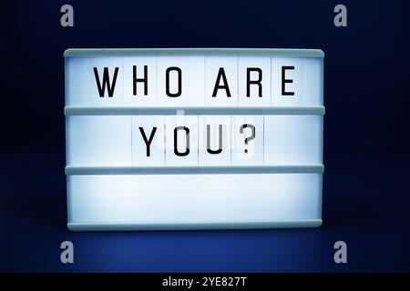 Who are You? letterboard text on LED Lightbox on blue background Stock Photo