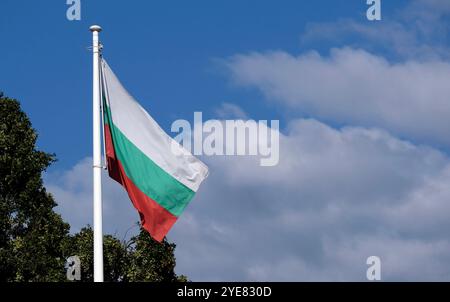The national flag of Bulgaria in the wind against a blue sky Stock Photo