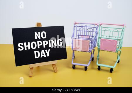 No shopping day text message and trolley shopping cart on yellow background Stock Photo