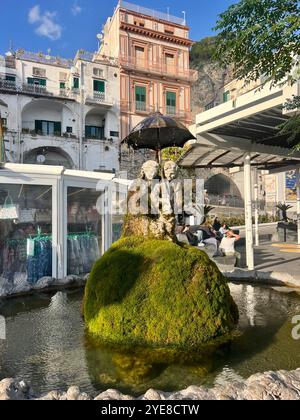 Amalfi Coast, Italy October 13 2024 A statue and tourists walking by along the pier in Amalfi . High quality photo Stock Photo