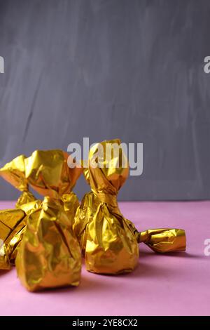 Dark chocolate bar golden wrapper white background Stock Photo - Alamy
