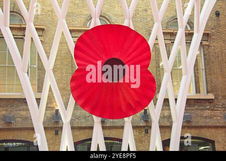 Kings Cross Station, London, UK 10-31-2014 when a gaint Red Poopy was mounted on the frame of the station canopy Stock Photo