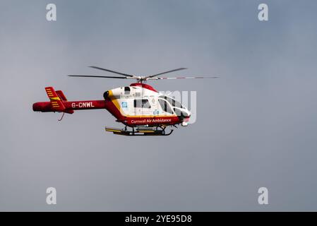 Cornwall Air Ambulance helicopter McDonnell Douglas MD 902 Explorer G-CNWL flying over Cornwall Airport, UK Stock Photo