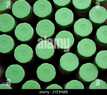 Arrangement of green plastic bottle caps; Studio Stock Photo