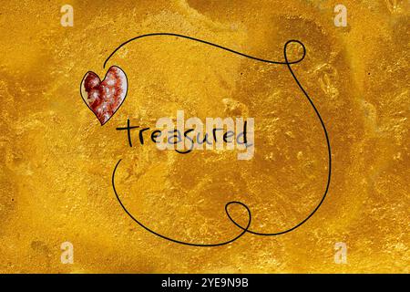 Ink art in gold with word 'treasured'; Artwork Stock Photo