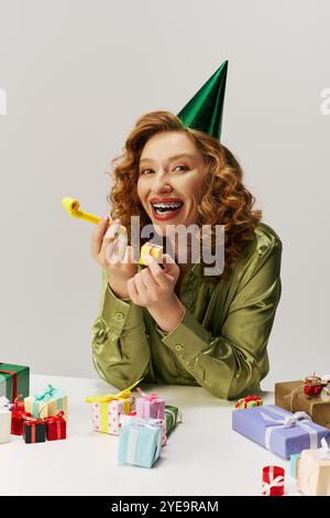 A cheerful young woman posing and celebrates surrounded by decorations. Stock Photo