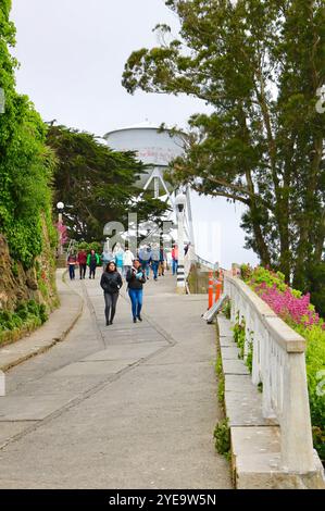 Alcatraz water tower with Native American graffiti and visiting tourists Alcatraz Federal Penitentiary Alcatraz Island San Francisco California USA Stock Photo