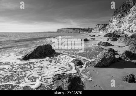 Surf washing up on the shore of Port Mos beach in the Lagos region of Portugal. The Praia do Porto de Mos is the second largest beach in the Lagos ... Stock Photo