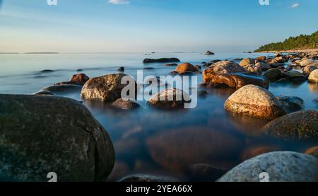 Natural stone located on the Swedish Baltic Sea coast where the sea is calm during the evening. Stock Photo