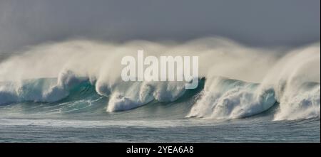 Powerful waves breaking with spray, intense wave activity on the Eastern shore of Maui, Hawaii, USA; Maui, Hawaii, United States of America Stock Photo