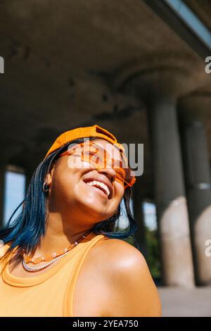 Happy young woman in cap and sunglasses at sunny day Stock Photo