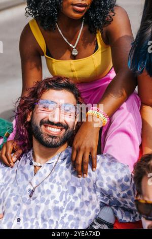 High angle view portrait of smiling man wearing sunglasses leaning on female friend at sunny day Stock Photo