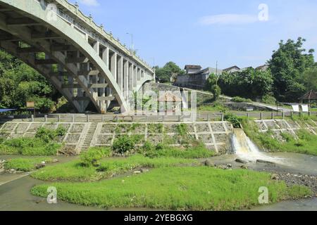 Rushing water in the drainage system from small canals enters large rivers. Stock Photo