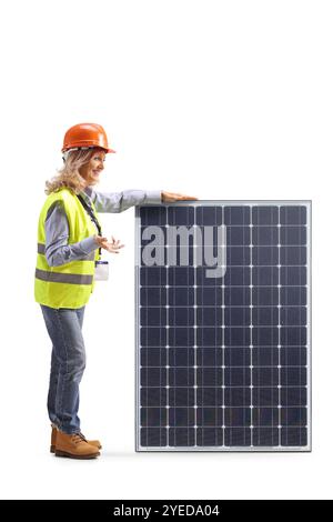 Female engineer standing next to a solar panel and talking isolated on white background Stock Photo