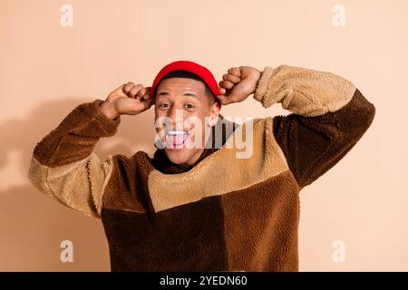 Photo of glad funny funky man wear trendy clothes good mood isolated on beige color background Stock Photo