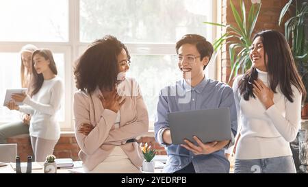 Friendly multiracial colleagues having conversation in office Stock Photo