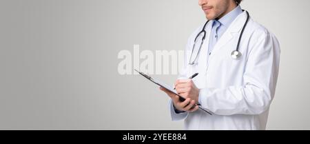 Unrecognizable male therapist writing notes to patient's medical history Stock Photo