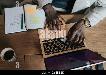Hands of businessman typing on laptop at desk Stock Photo