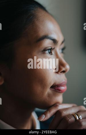 Close-up of businesswoman with hand on chin Stock Photo