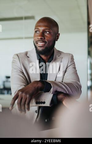 Smiling bald businessman standing in office Stock Photo