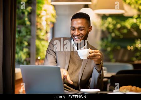 Man sitting in a cafe drinking cup of coffee Stock Photo