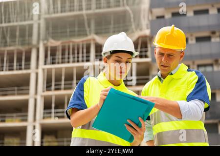 Two qualified engineers are discussing a construction plan Stock Photo