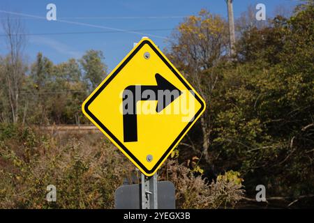 Right turn symbol on yellow sign in public park Stock Photo