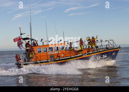 The crew of the Aldeburgh Lifeboat waving to the crowds on the beach, as the Lifeboat Freddie Cooper retires from service. Stock Photo