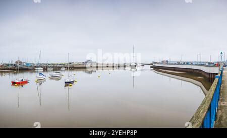 A multi image panorama of boats reflecting in the calm water of the River Clwyd as it snakes through the harbour at Rhyl, North Wales on 30 October 20 Stock Photo