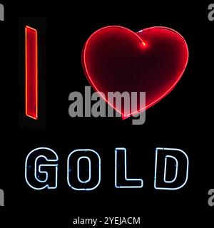 Squared picture of a neon light glowing on a black background. This picture is a composite of three different neon. A red capital "I", a heart and the Stock Photo