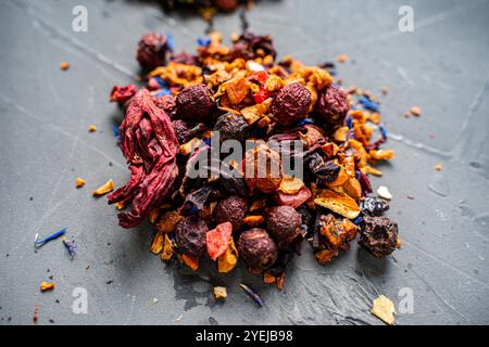 Dry red hibiscus tea with various additives ha gray background. High quality photo Stock Photo