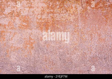 Concrete textured wall surface with shades of pink, orange, and brown, appearing weathered. Stock Photo