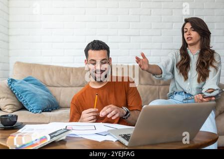 Side hustle. Young university students, architectural design experts, working on housing development project to earn money. Couple build their sustain Stock Photo