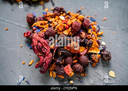 Dry red hibiscus tea with various additives ha gray background. High quality photo Stock Photo