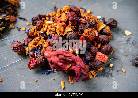Dry red hibiscus tea with various additives ha gray background. High quality photo Stock Photo