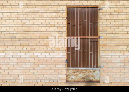 Brick Wall with Rusty Metal Door and Padlock Stock Photo