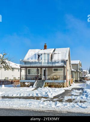 Small old family residential house on sunny winter day in Canada Stock Photo