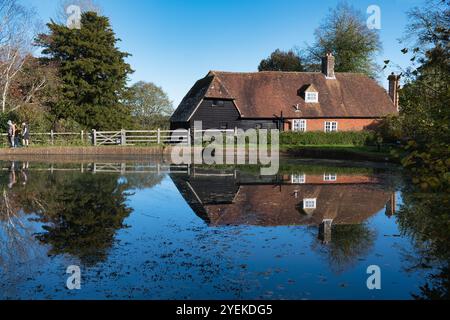 Visitors enjoying the grounds of Bateman's, the former home of Rudyard Kipling on a sunny day in Autumn Stock Photo