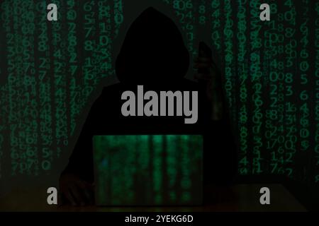 Hacker over a screen with binary code. concept of a hacker attack Stock Photo