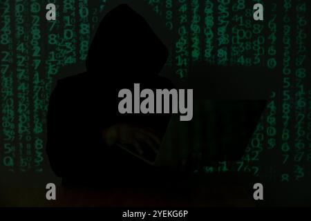 Hacker over a screen with binary code. concept of a hacker attack Stock Photo