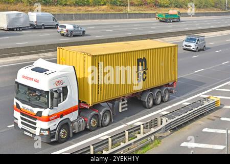 MSC shipping container on articulated skeletal trailer towed by Macintyre Transport Scania hgv lorry truck eight lane M25 motorway road Essex England Stock Photo