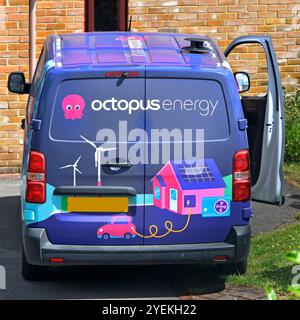 Back view colourful octopus energy van parked at home property engineer installs new EV car charging equipment inside domestic garage Essex England UK Stock Photo