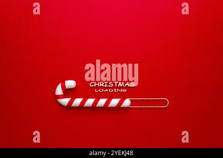 Candy cane on red background. Minimal Christmas loading concept. Stock Photo