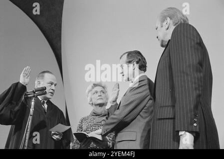 George H. W. Bush being sworn in as director of the Central Intelligence Agency (CIA), with his wife Barbara Bush and President Gerald Ford, Washington, D.C., USA. 4 February 1976 Stock Photo