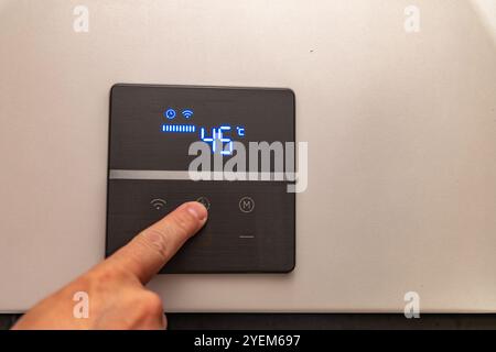 Electronic panel for setting the temperature in the water heater furnace Stock Photo