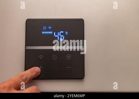 Electronic panel for setting the temperature in the water heater furnace Stock Photo