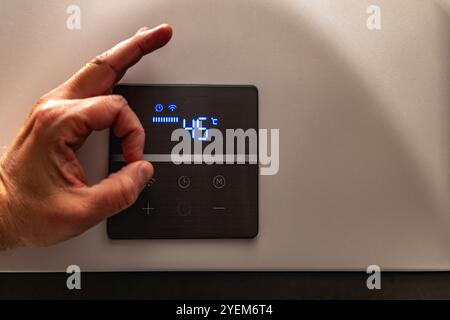 Electronic panel for setting the temperature in the water heater furnace Stock Photo