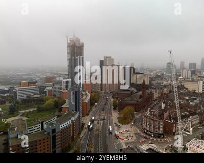 Aerial view of birmingham, uk, city center with construction cranes and buildings rising from the fog Stock Photo